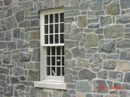 Irregular grey granite masonry around a rectangular window
