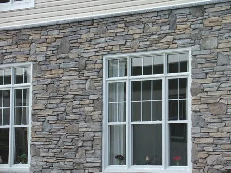 Manufactured ledge-style veneer around white-framed windows