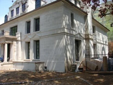 Cut limestone façade with smooth block faces and architectural profiles