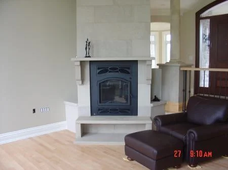 Indiana limestone fireplace with pale rectangular stonework and a projecting hearth