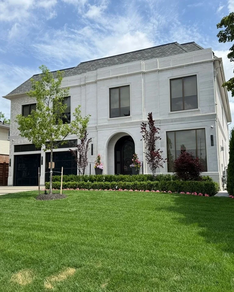 Formal pale limestone house with an arched entrance, featured by Allstone as Alabama limestone