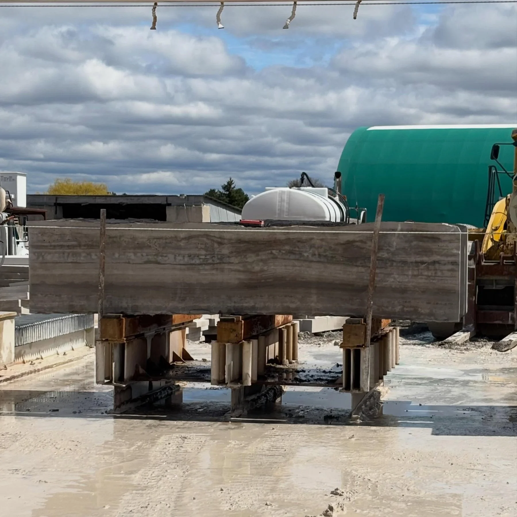 Stone cutting equipment and a large stone slab in Allstone’s workshop