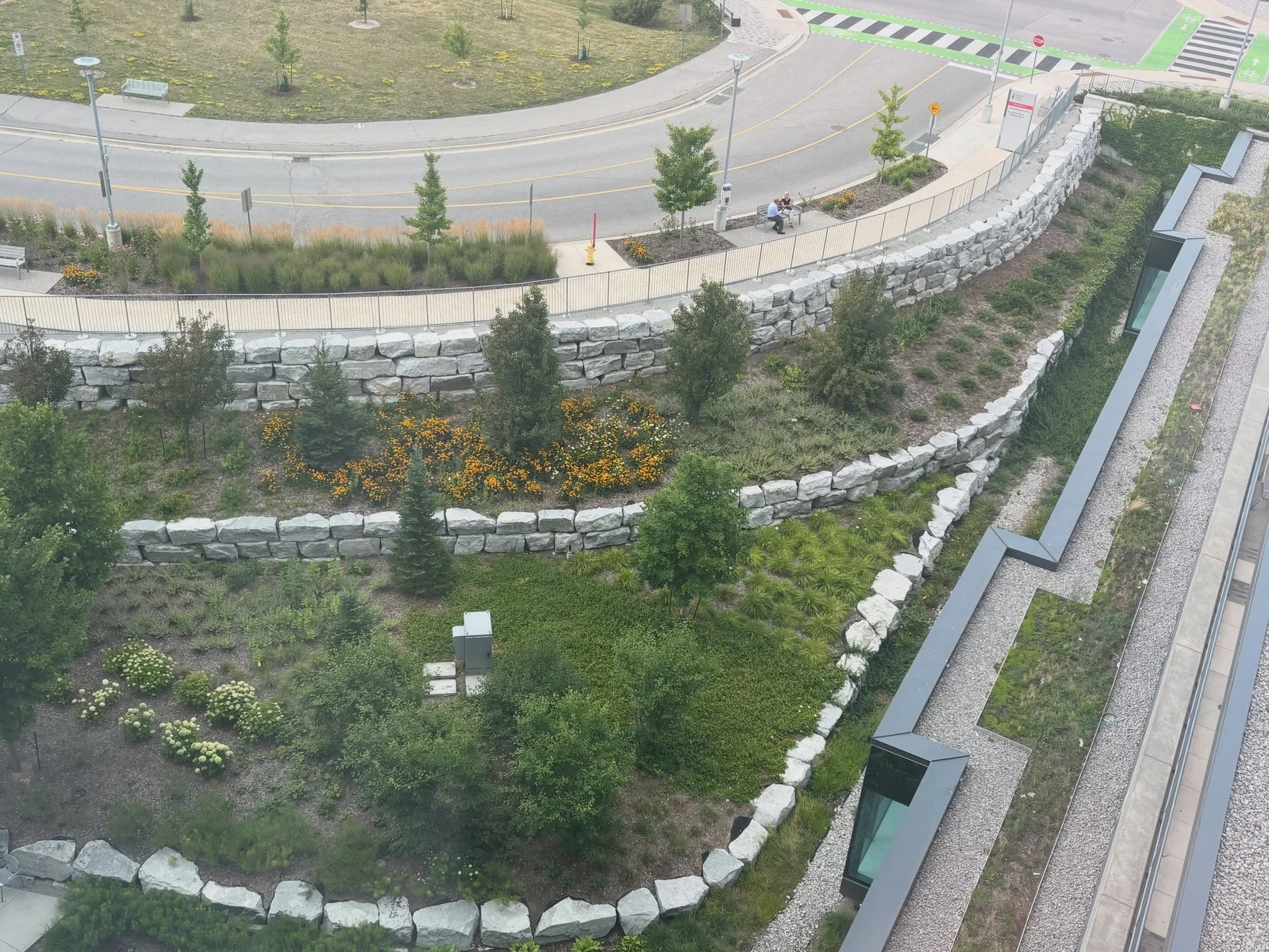 Planted terraces framed by curved natural stone retaining walls