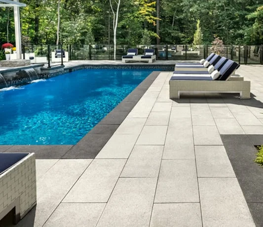 Large-format outdoor paving surrounding a pool and seating area