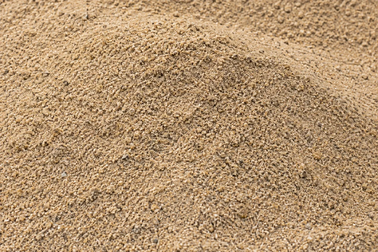 Fine natural tan sand with a gently sloping granular surface