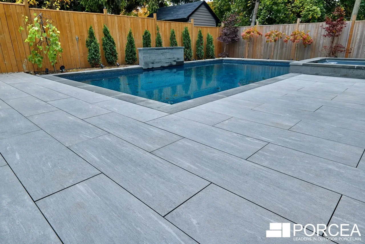 Porcea Greige porcelain paving around a pool at an Aurora residence, from Porcea Stone’s official gallery